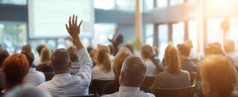 The engaging audience at a dynamic professional seminar raising hands for questions. photo