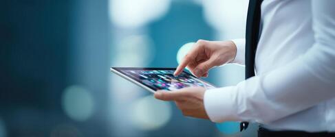 The businessman interacting with a tablet in a modern urban environment. photo