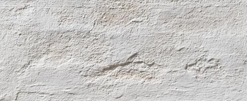 The textured white wall showcasing a rustic and minimalist surface design. photo
