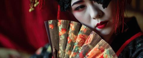 The Elegant Geisha Holding a Beautiful Floral Fan in Traditional Attire photo