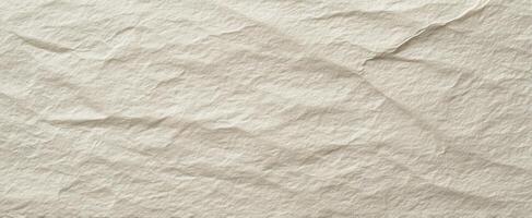 The textured surface of crumpled beige paper creates an artistic background. photo