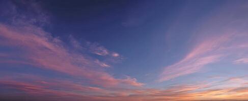 The stunning sunset sky painting with vibrant colors and soft clouds. photo