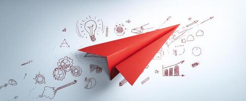 The red paper airplane soaring above creative business illustrations and ideas. photo