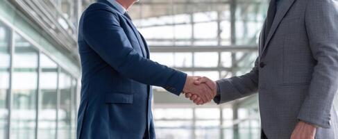 The Businessmen Engaging in a Professional Handshake in a Modern Office Setting photo