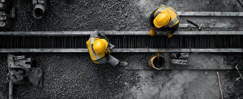The construction workers collaborating on a project in a busy site environment. photo