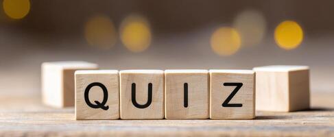 The Wooden Blocks Spelling Out 'Quiz' on a Rustic Surface photo