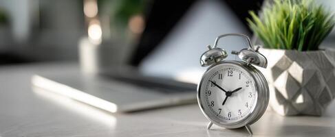 The elegant alarm clock beside a stylish workspace with greenery. photo