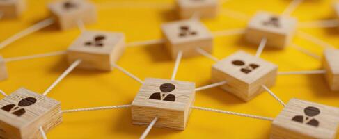 The network of interconnected people represented by wooden blocks and strings. photo