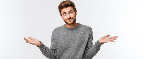 The man shrugging with a confused expression in a casual setting. photo