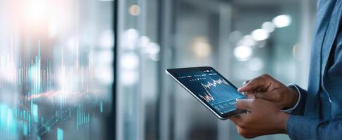 The tablet displaying financial data and analytics in a modern office setting. photo