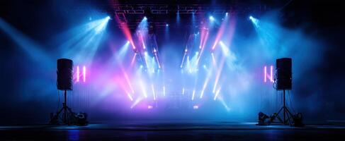 The vibrant concert stage illuminated by colorful lights and dramatic fog. photo