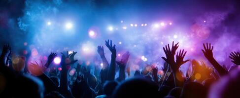 The vibrant crowd immersed in an electrifying concert experience at night photo