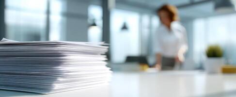 The busy office scene showcasing stacked paperwork with a professional at work. photo