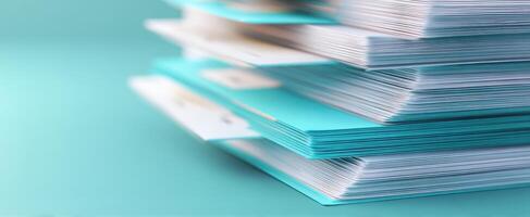 The vibrant stack of organized documents on a turquoise background. photo