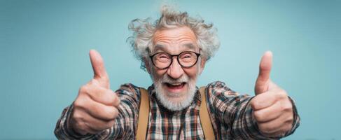 The joyful elderly man giving two thumbs-up with a big smile. photo