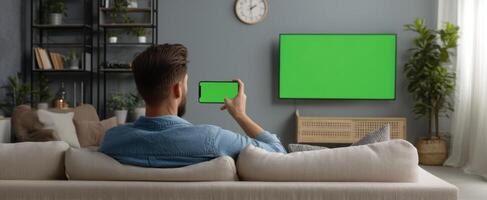 The man enjoying digital content on smartphone in modern living room photo