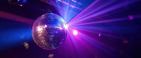 The sparkling disco ball reflecting vibrant lights in a lively party atmosphere. photo