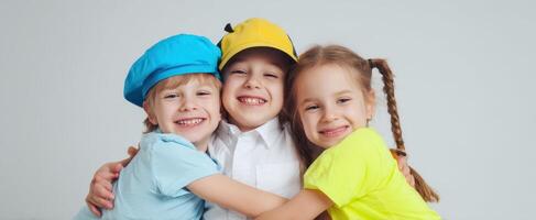 The joyful children in colorful hats sharing an affectionate hug. photo