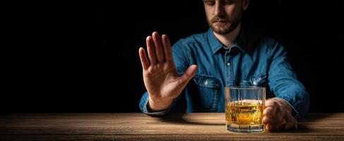 The man refusing to drink whiskey, showcasing an internal conflict. photo