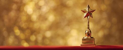 The Golden Star Trophy on a Red Tablecloth with a Shimmering Background photo
