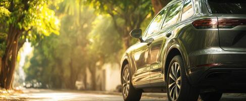 The modern luxury SUV parked under sunlit trees in a serene urban setting photo