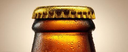 The refreshing beer bottle with condensation and a golden cap. photo