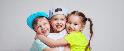 The joyful children embracing each other in colorful attire and hats. photo