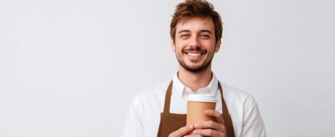 A man in an apron holding a coffee cup photo