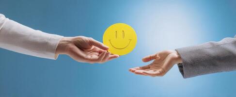 The hands exchanging a cheerful smiley face symbolizing positivity and collaboration. photo
