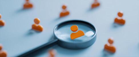 The magnifying glass focuses on a single person among many icons photo