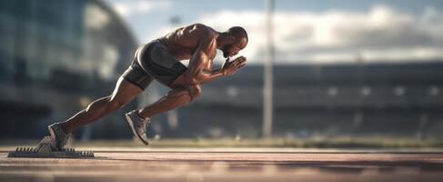 The athlete poised for sprinting at the starting line on track field. photo