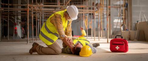 The construction worker administering first aid during an emergency situation at a site. photo