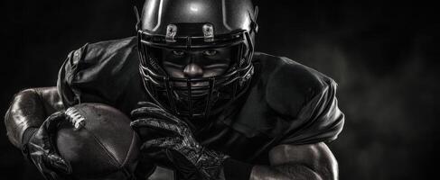 The powerful football player in a dramatic black and intense action pose. photo