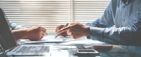 The collaborative discussion between professionals over important business documents. photo