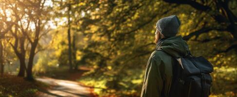 The traveler enjoying solitude in a serene autumn forest setting. photo