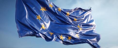The European Union flag waving gracefully in a clear blue sky photo