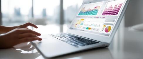 The laptop displaying various data visualizations and analytics for business insights photo