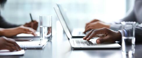 The collaborative workspace featuring professionals engaged with laptops and documents. photo