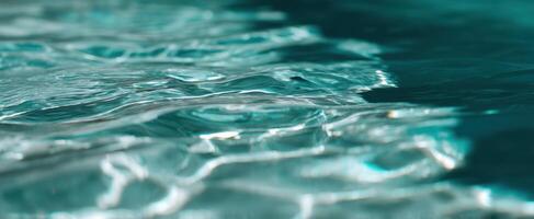 The shimmering turquoise water surface with soft ripples and reflections photo