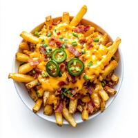 Loaded cheese fries with cheddar, crispy bacon bits, and jalapenos arranged on white background photo