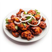 A plate of chicken 65, with crispy chicken pieces marinated in spices and deep-fried, served with photo