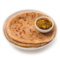 A close-up of a flaky paratha, with layers of whole wheat dough and a golden brown color, served photo