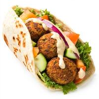 An image of a colorful falafel wrap, featuring falafel, vegetables, and tahini sauce in a pita bread photo