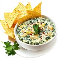 A bowl of spinach and artichoke dip, with a creamy blend of spinach, artichokes, cream cheese, and photo
