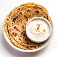 A bowl of yogurt and two flatbreads photo