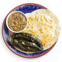 A vibrant plate of rajas con queso, roasted poblano peppers cooked with onions and melted cheese, photo