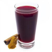 A glass of juice with cinnamon and cinnamons photo