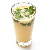 A glass of juice with a green garnish photo