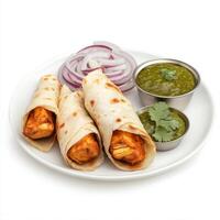 A plate of chicken 65 roll, with chicken 65 pieces wrapped in a flaky paratha, with onions and chutney, isolated on clean white background. photo