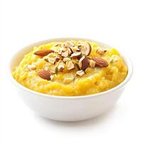 A bowl of moong dal halwa, with a sweet pudding made from mung beans, milk, and sugar, garnished with nuts and cardamom, isolated on clean white background. photo